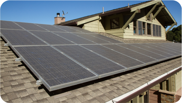 Image of solar panels on a roof of a green cape house
