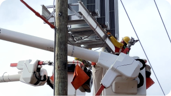 utility worker in a bucket truck working on a 'circuit-tie'